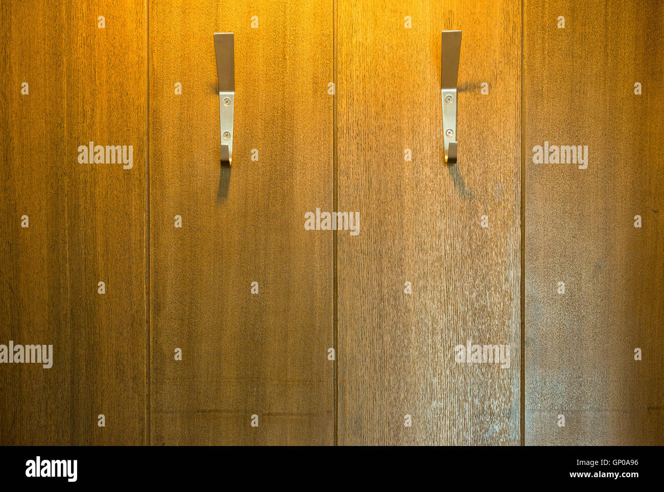 Two Steel Wall Hangers, Wall Hooks for coats on wooden board background