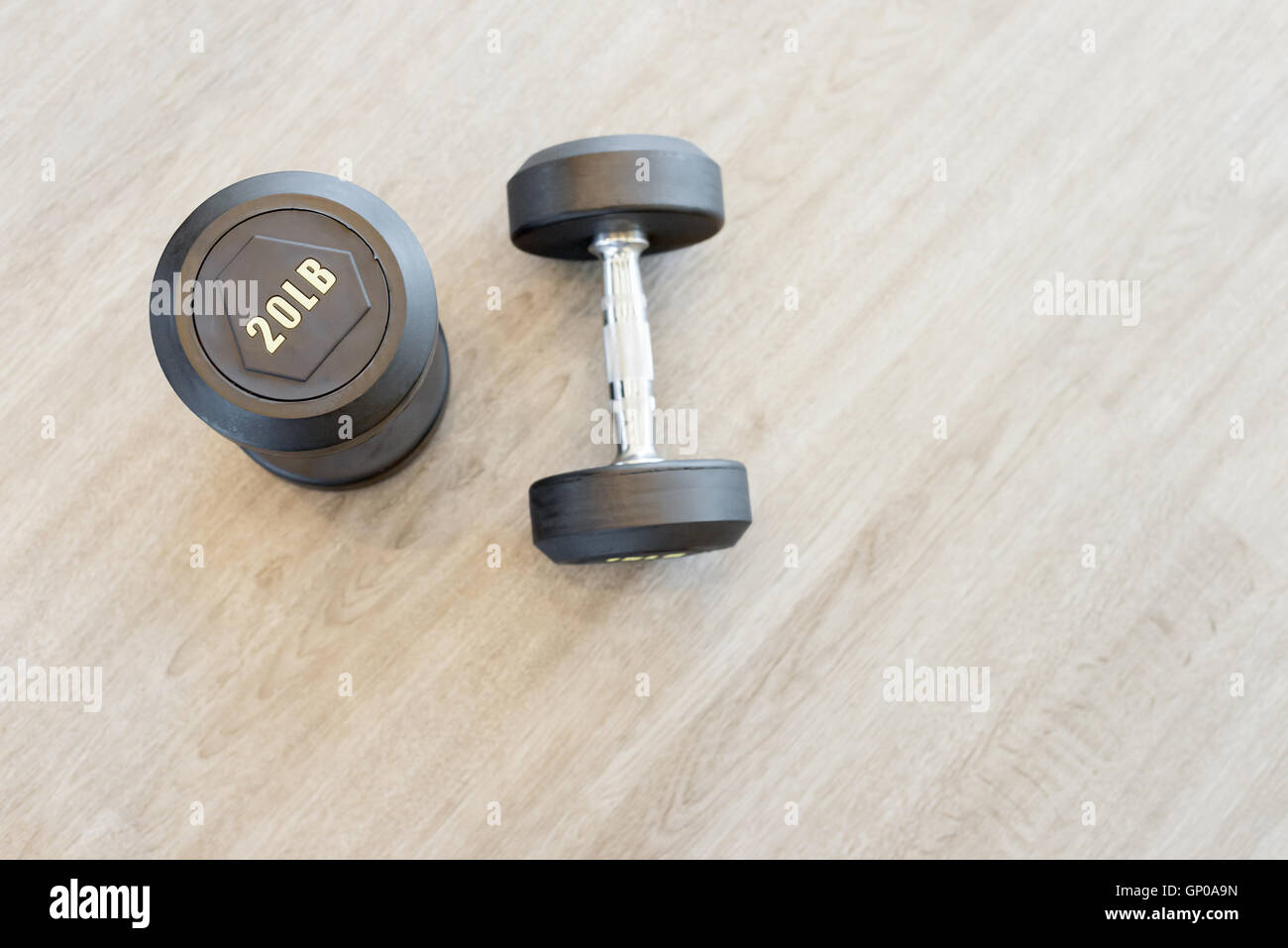 Two dumbbells on the floor in a hall Stock Photo