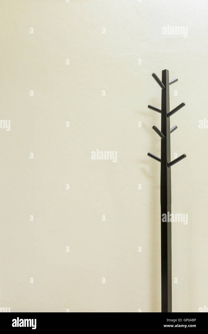 Black wooden coat rack on wall background, copy space. Stock Photo