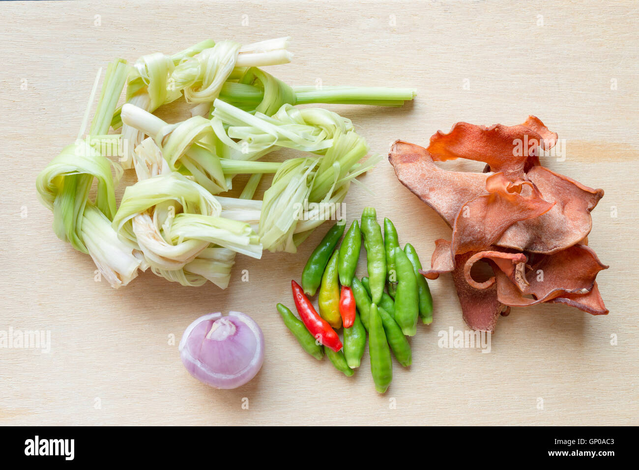Standard herbal Ingredients for Thai spicy soup, sour soup, curry. Top view on wooden utensils. Stock Photo