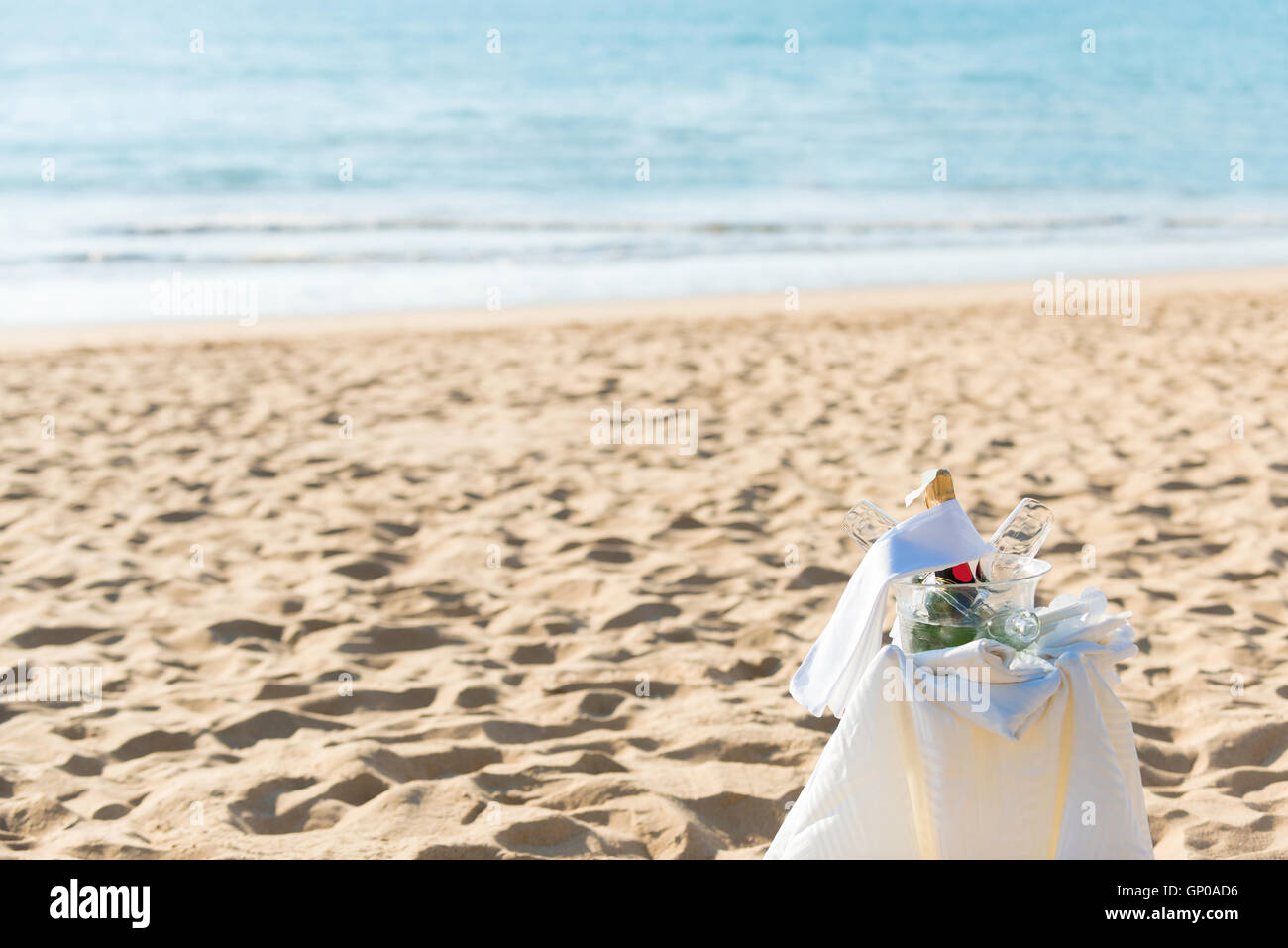 Chilled champagne and wine glasses in bucket setup on the beach. Stock Photo
