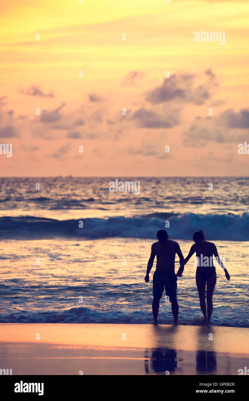 Seascape, beautiful sunset beach with silhouette couples together. Stock Photo