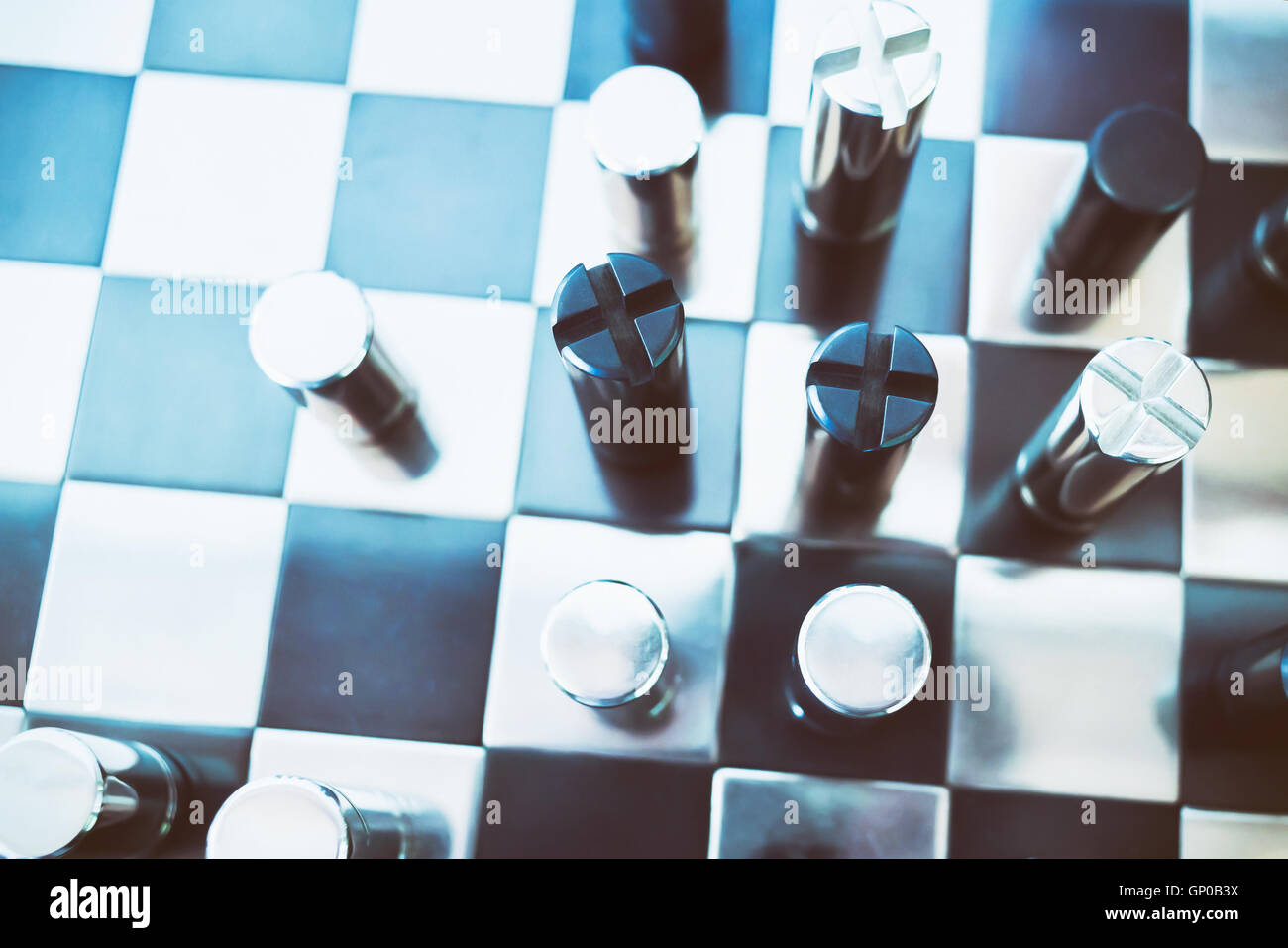 Black & chrome metallic chess on board. Business concept: Market competition and usurp business opportunities. Stock Photo