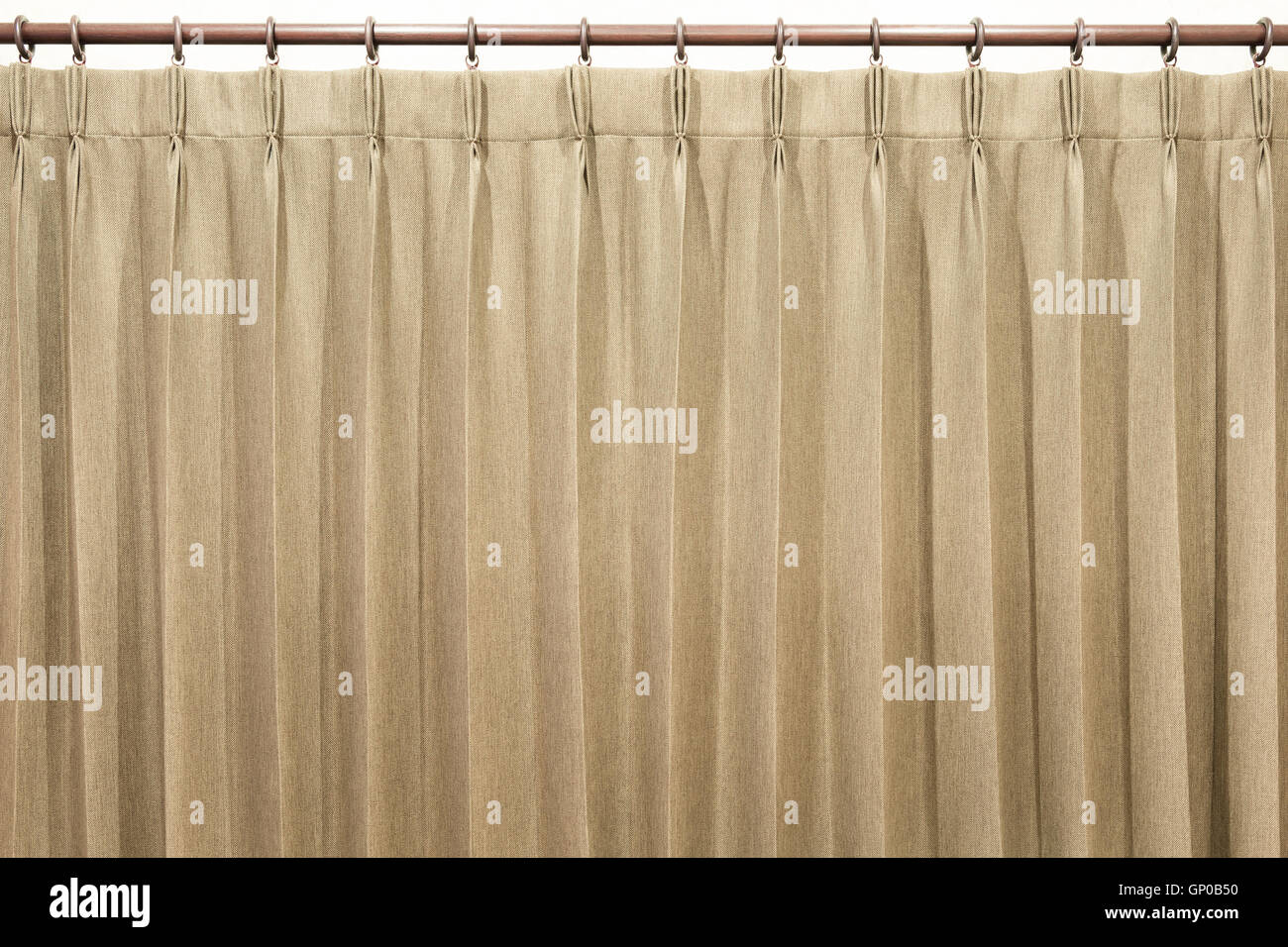Brown curtains hang on the curtain rail. Isolated. Stock Photo