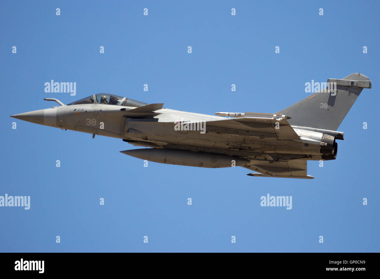 French Navy Dassault Rafale fighter jet flyby on a blue sky Stock Photo