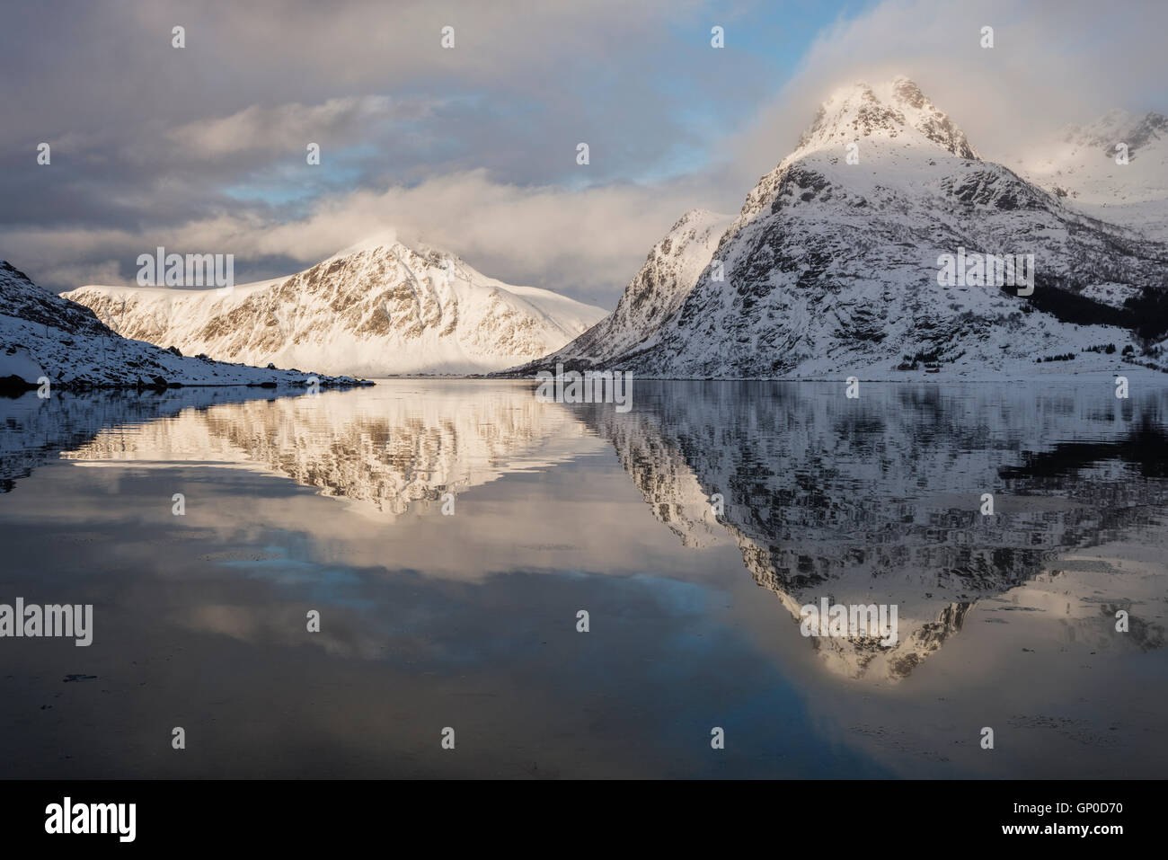 Winter mountain reflections in calm water of Flakstadpollen, Flakstadøy, Lofoten Islands, Norway Stock Photo