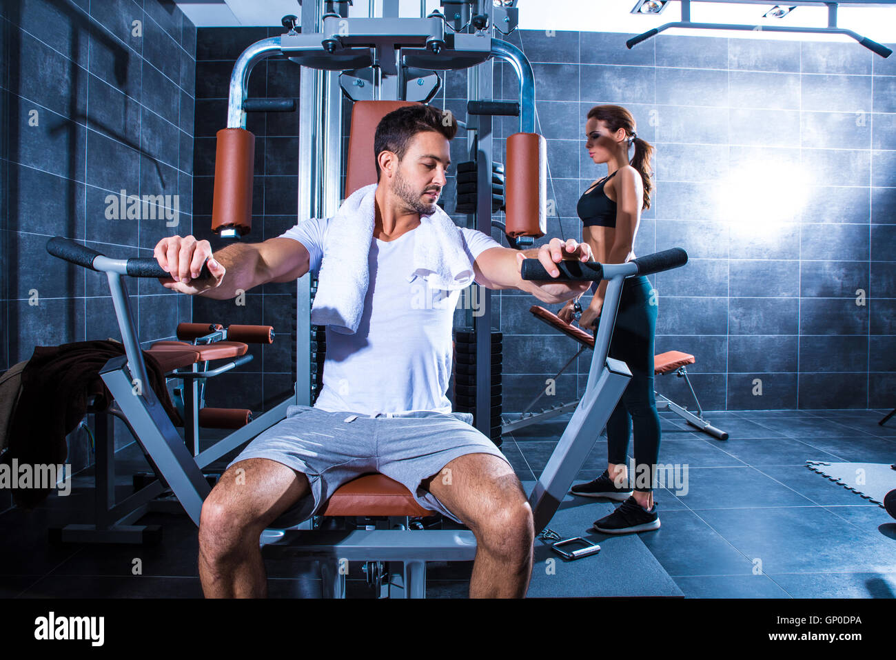 A young couple training together in the Gym Stock Photo - Alamy