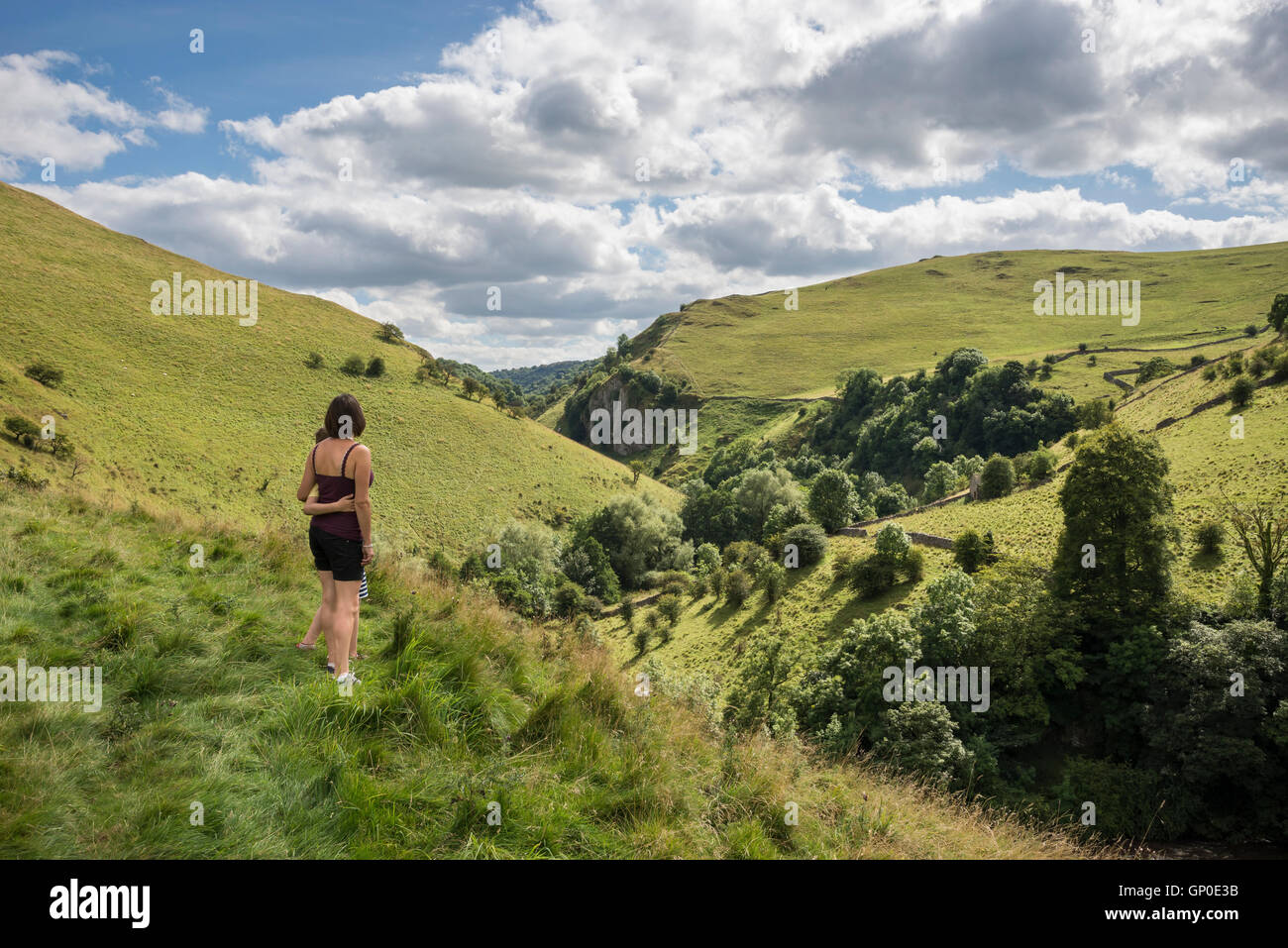 A mother and son admire a view of the Dove Valley near Milldale in the Peak District national park. Stock Photo