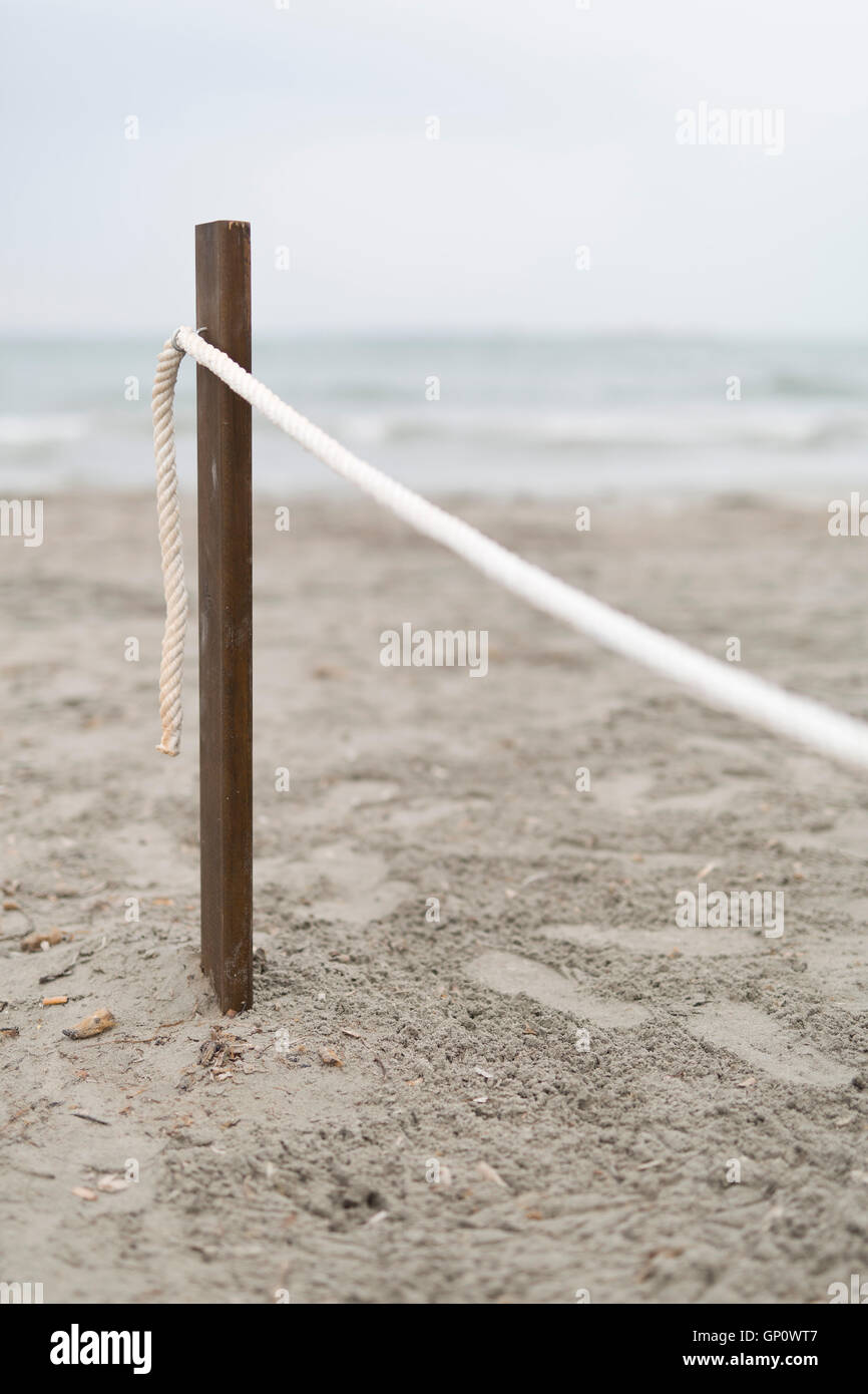 Stick with a rope in the sand on a Spanish beach Stock Photo Alamy