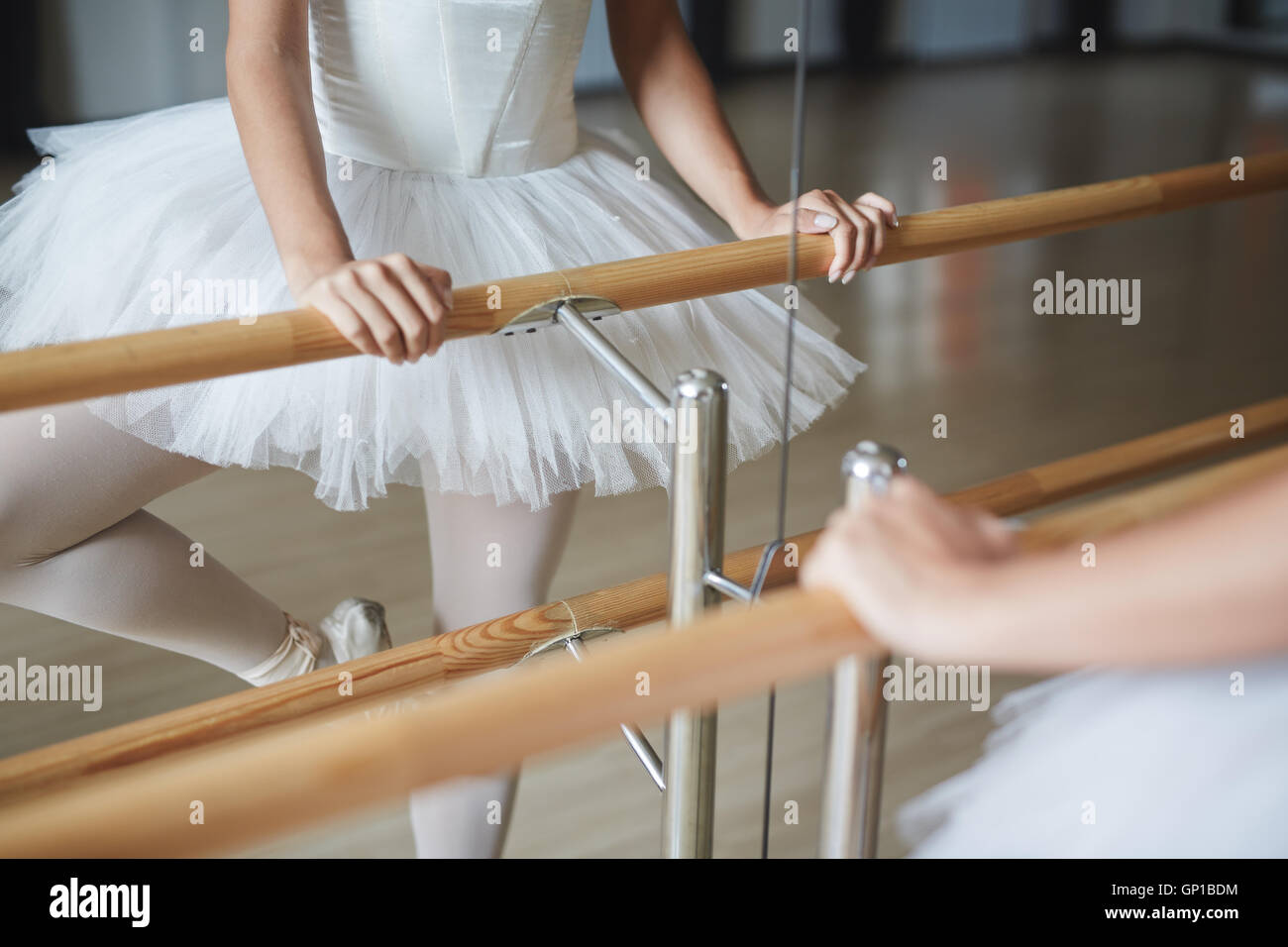 Ballerina holding wooden handrail during repetition Stock Photo - Alamy