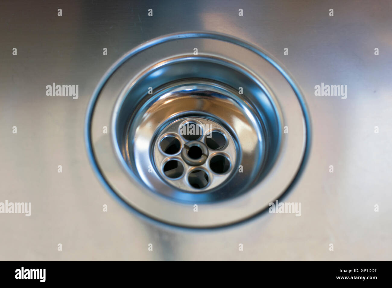 close up of a stainless steel sink plug hole Stock Photo