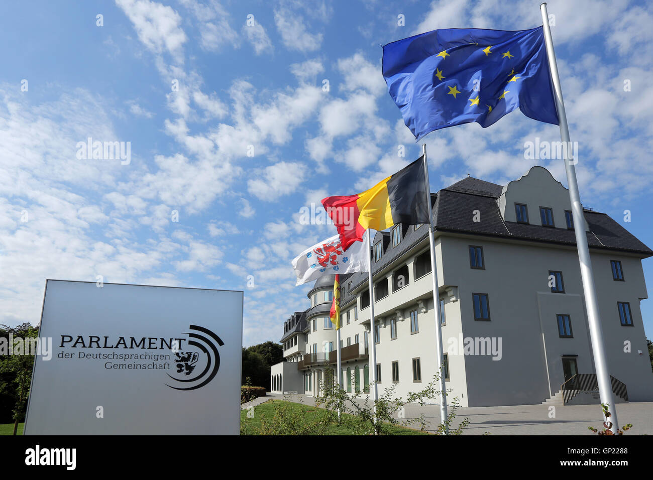 Parliament building of the German speaking Community in Eupen, Belgium. Flags from left to right: City of Eupen, German-speaking Community, Belgium, Europe Stock Photo