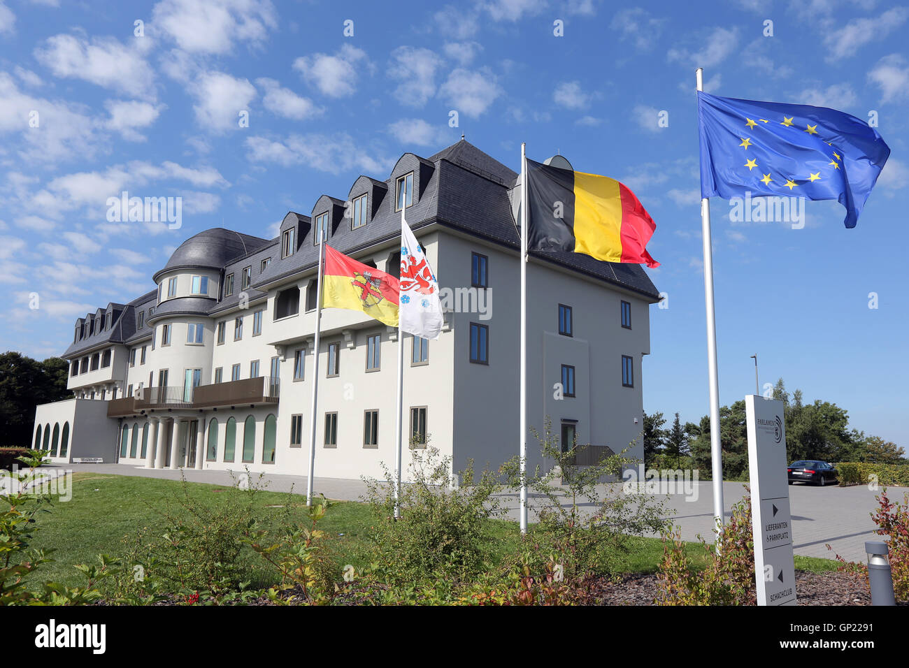 Parliament building of the German speaking Community in Eupen, Belgium. Flags from left to right: City of Eupen, German-speaking Community, Belgium, Europe Stock Photo