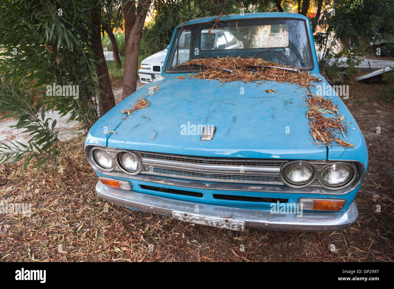 Zakynthos, Greece - August 16, 2016: closeup front view of old blue Datsun 1300 pickup car Stock Photo
