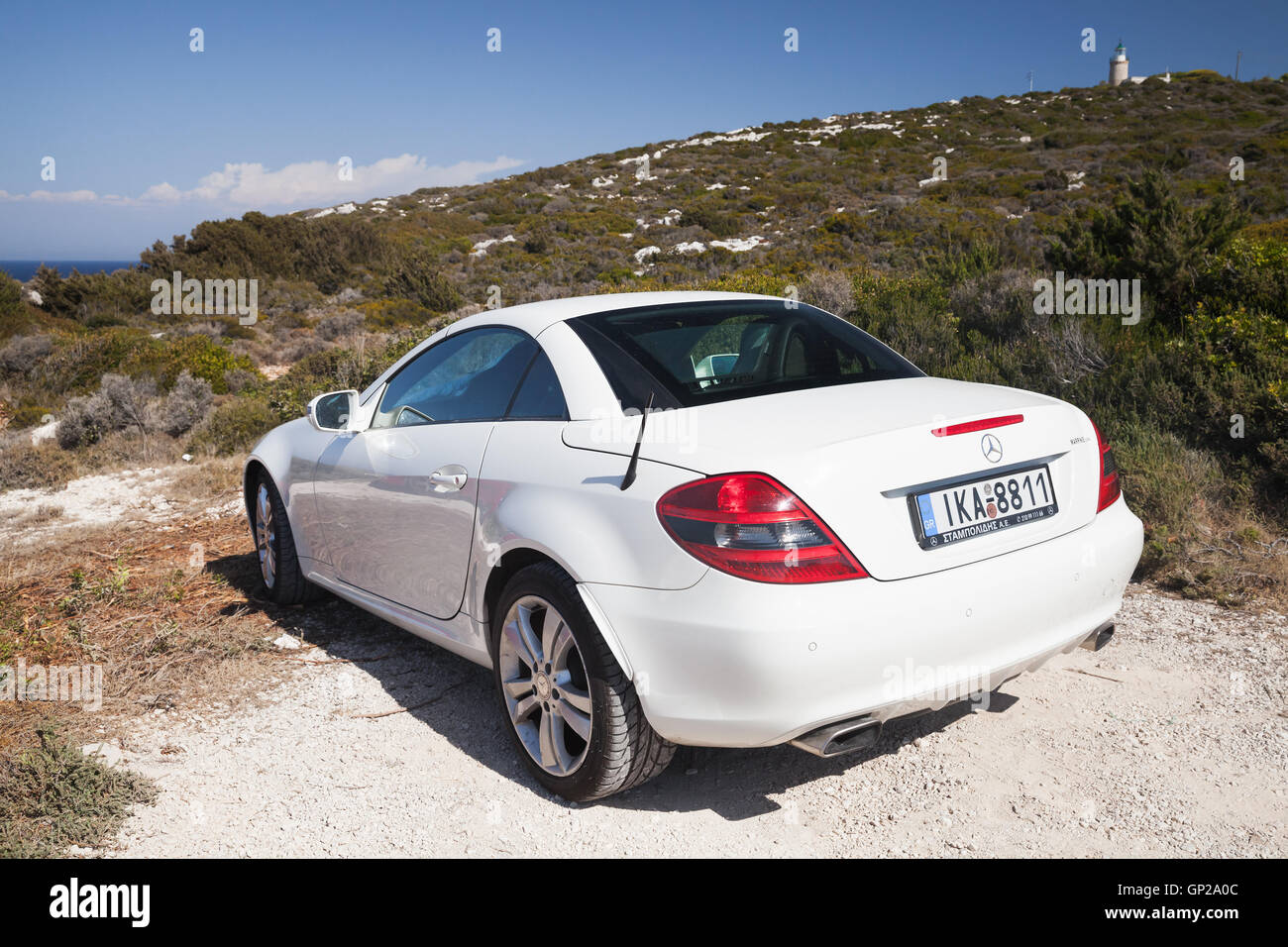Zakynthos, Greece - August 20, 2016: White Mercedes-Benz SLK 200 pre-facelift car stands on the roadside in summer, rear view Stock Photo