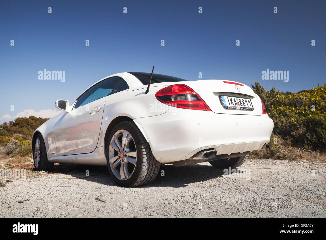 Zakynthos, Greece - August 20, 2016: White Mercedes-Benz SLK 200 pre-facelift car stands on the roadside in summer, closeup rear Stock Photo