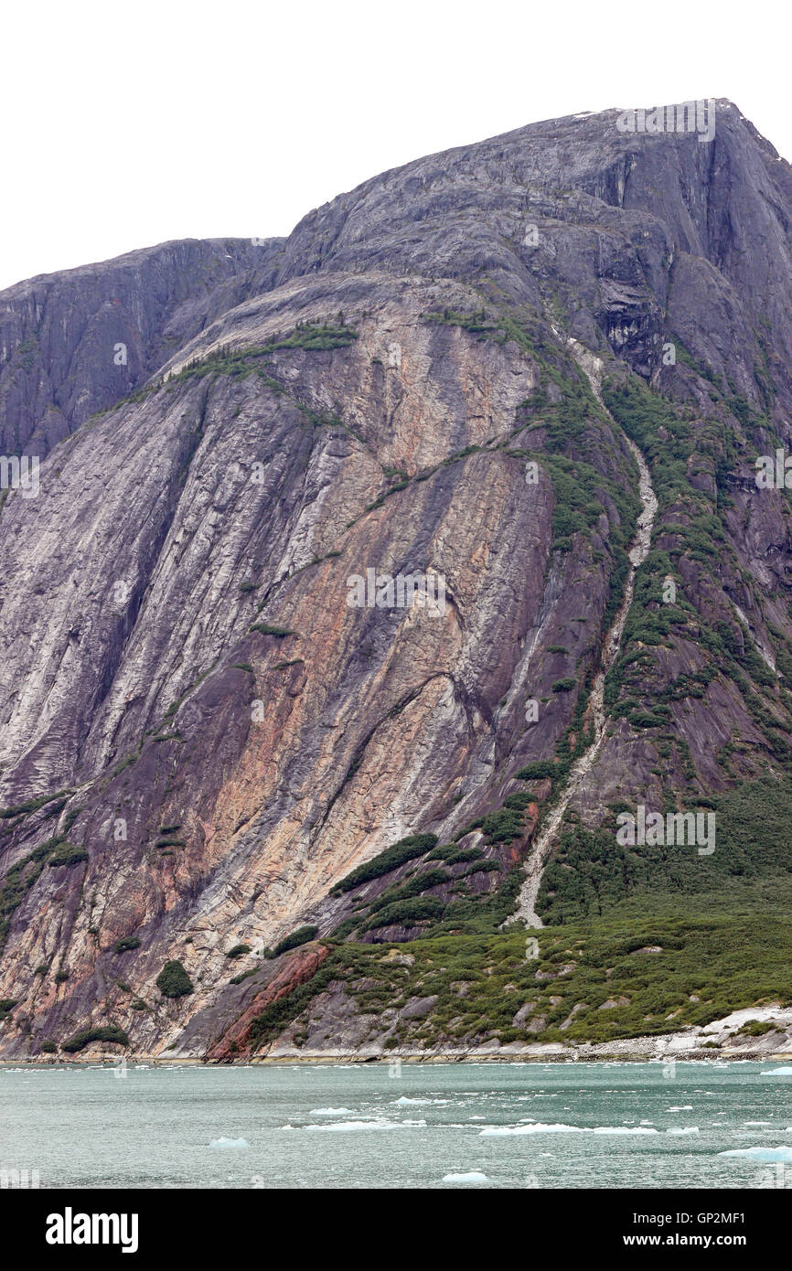 Indian Head on rock cliff by Dawes Glacier Endicott Arm Inside Passage Southeast Alaska USA Stock Photo