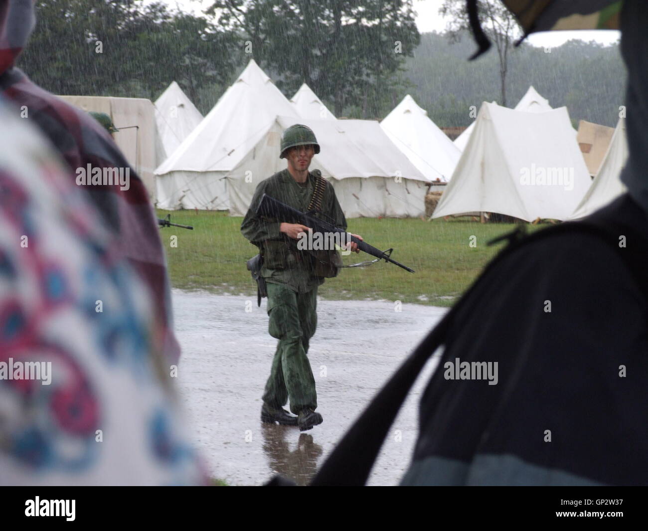 US soldier patrolling in the rain Stock Photo