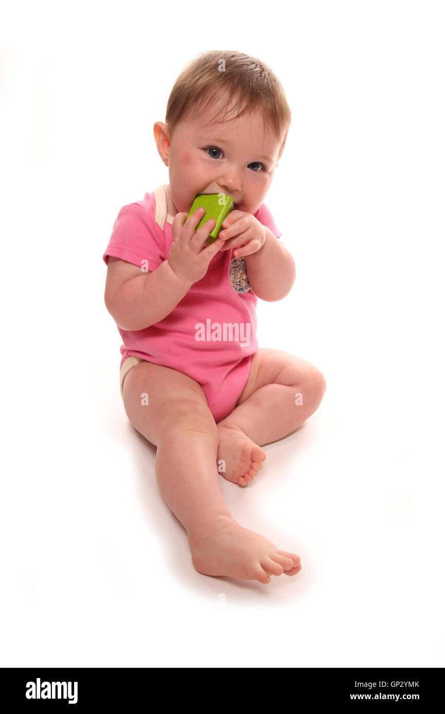 Baby girl playing with wooden block cutout Stock Photo
