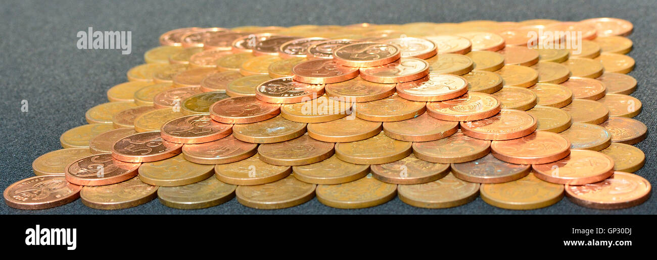 Pyramid of coins also forming a cross. Pyramid scheme. Stock Photo