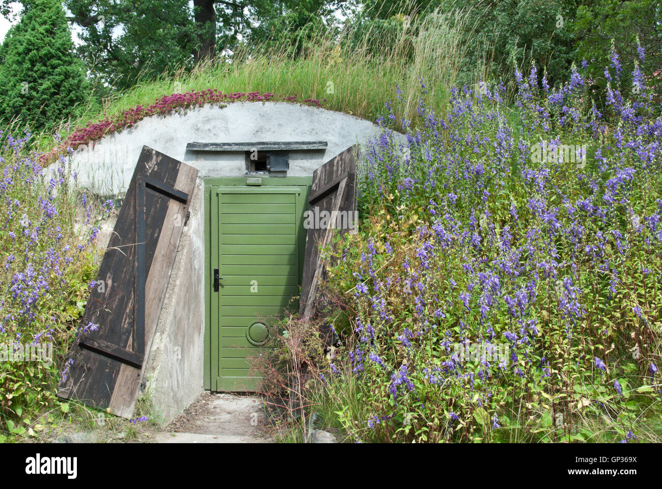 Underground dwelling under a blooming hill Stock Photo