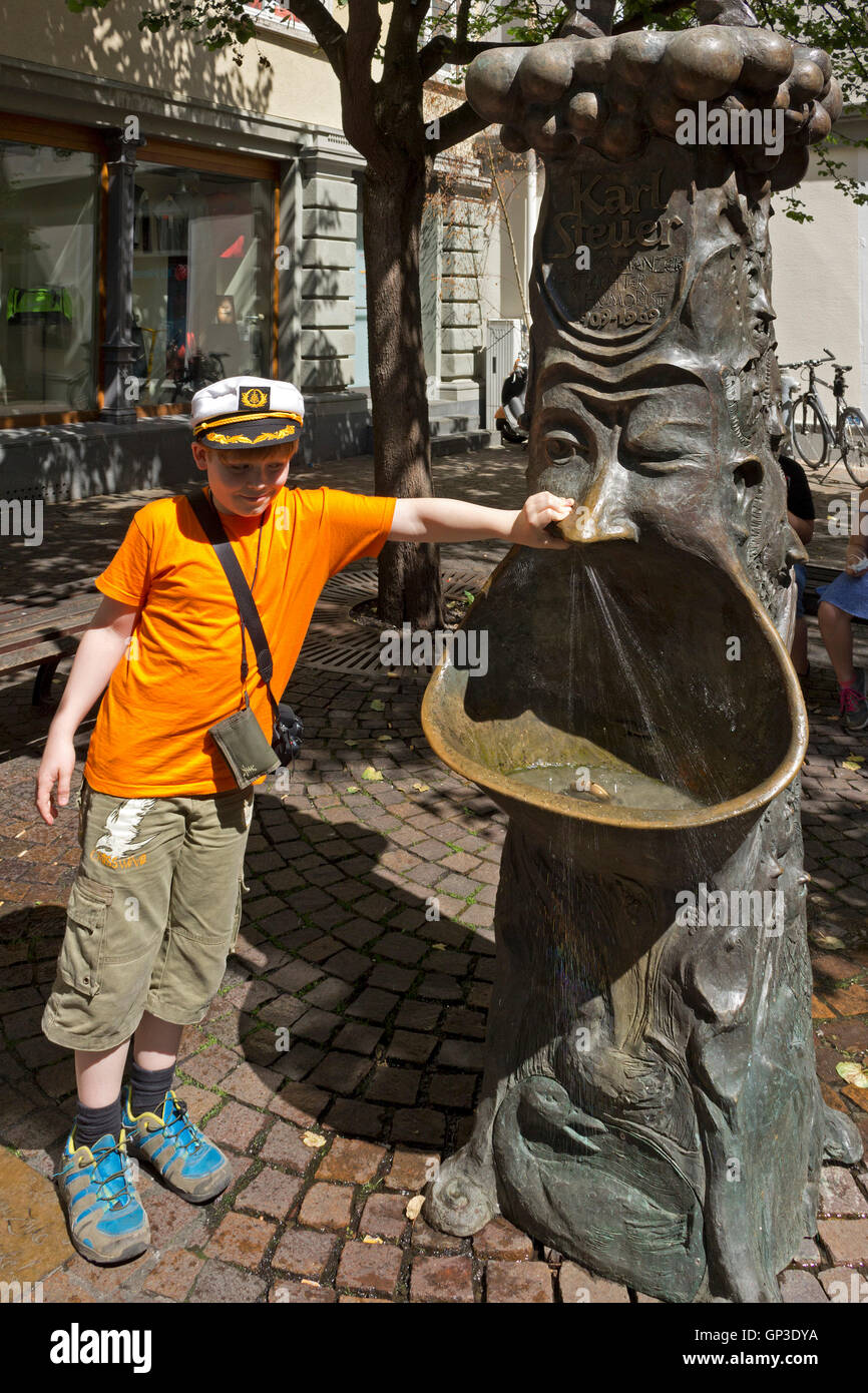 boy beside fountain, old town, Constance, Lake Constance, Baden-Wuerttemberg, Germany Stock Photo