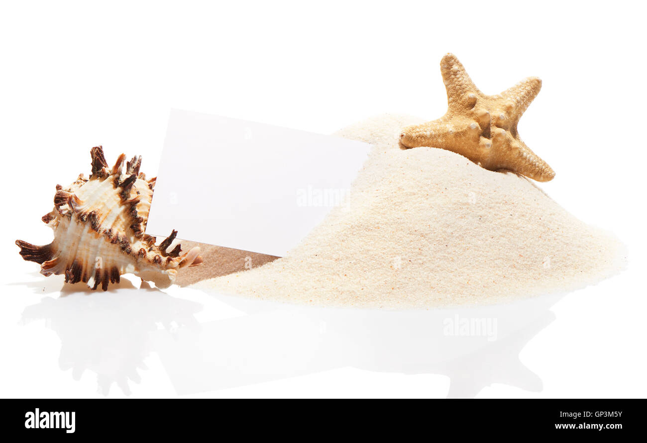 Blank white visit card with starfish and sea shell on pile of beach sand, isolated on white background Stock Photo