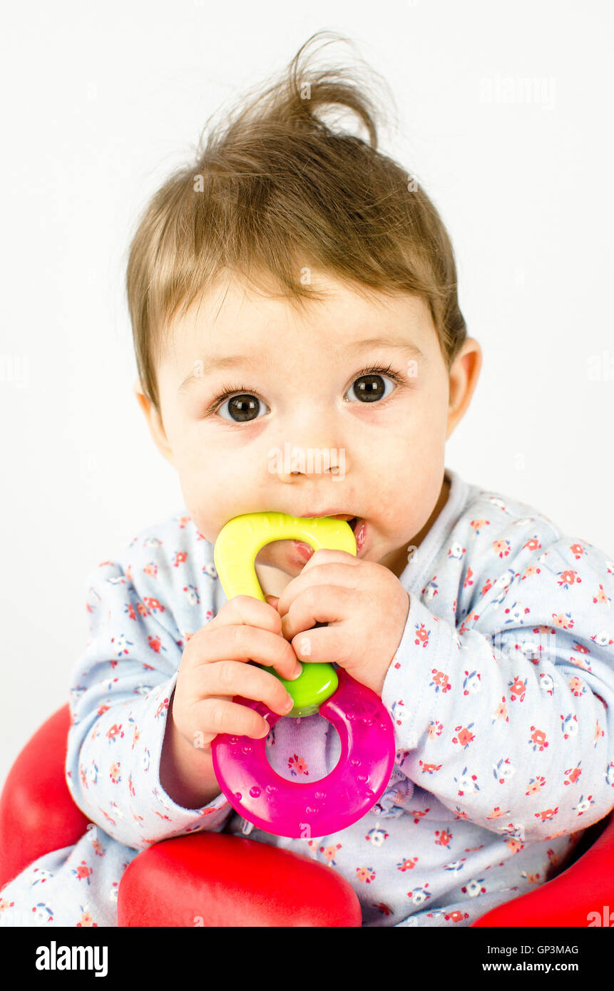 adorable baby girl teething and chewing teethers Stock Photo Alamy