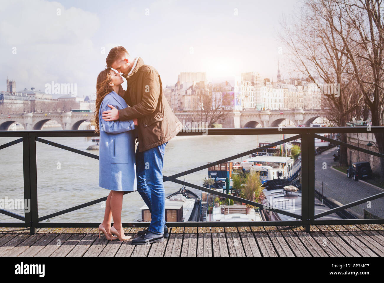 romantic date, young couple kissing on the bridge in Paris Stock Photo