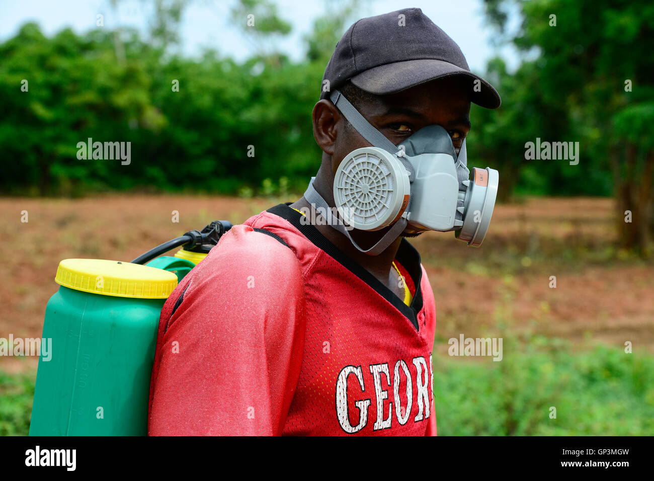 BURKINA FASO, Bobo Dioulasso, use of herbicide glyphosat Herbo Total 360 SL of chinese company Agrohao Co. Ltd. , worker with respirator mask Stock Photo