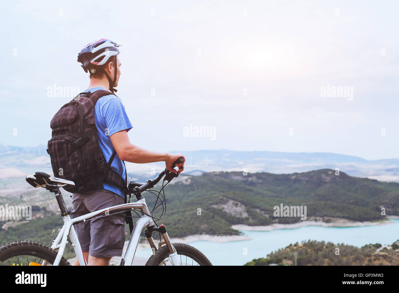 cycling in mountains, background, man looking at the panoramic landscape Stock Photo