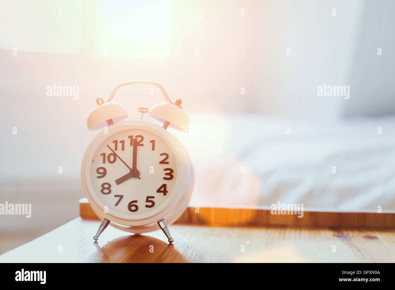 morning time background, alarm clock near the bed at home Stock Photo