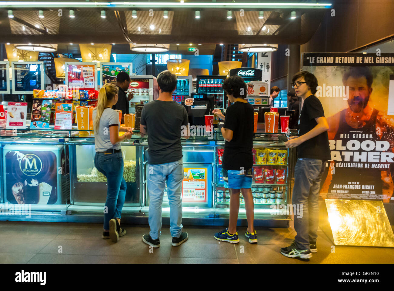 Paris, France, Interior, Small Group French People,from behind, Teenagers Buying Snacks at Shop in "Ciné Cité", Cinema Multiplex THeater, in the Neighbourhood, teenagers inside cinema Stock Photo
