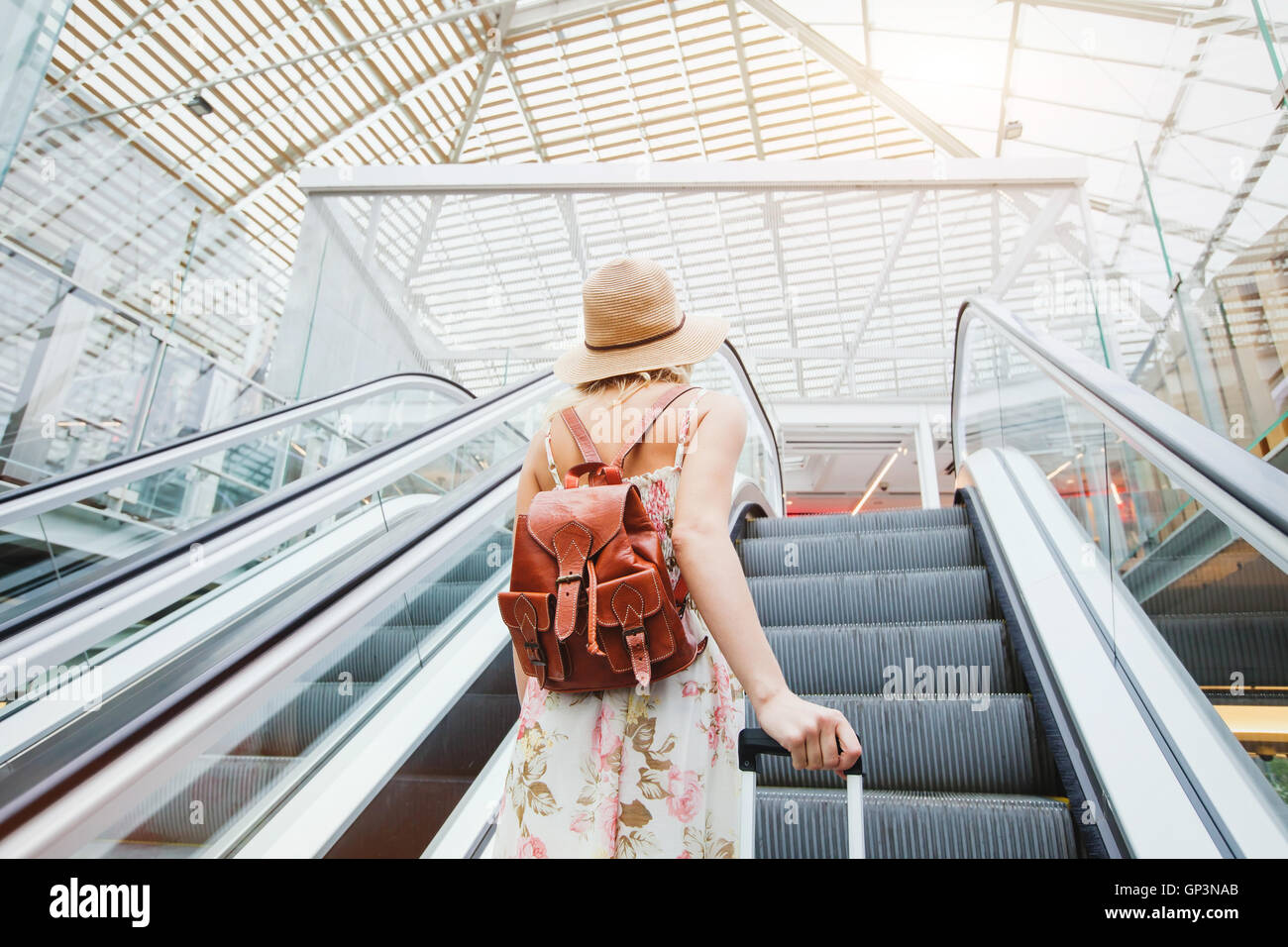 woman in modern airport, people traveling with luggage Stock Photo