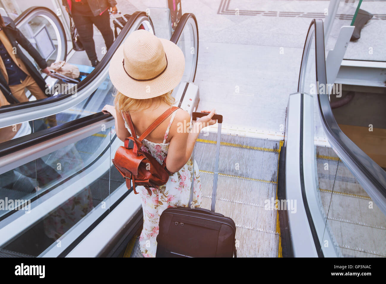 passenger in airport or modern train station, woman commuter with luggage Stock Photo