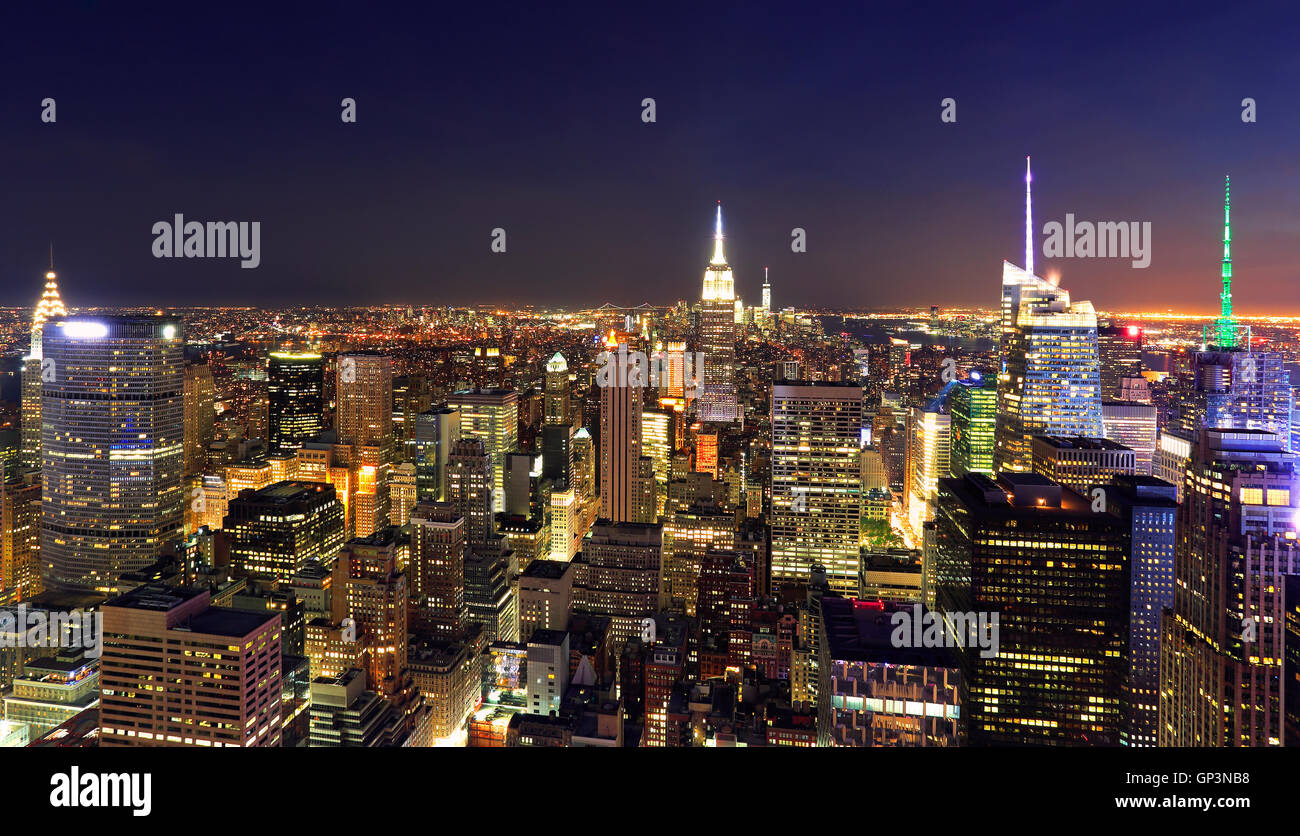 New York City skyline illuminated at night, USA Stock Photo