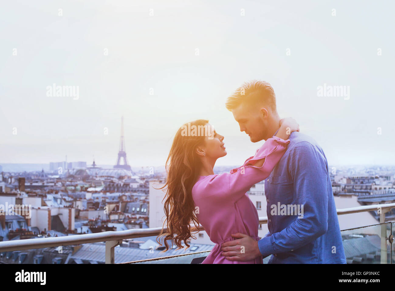 romantic couple in Paris, happy moment on Eiffel Tower background, honeymoon Stock Photo