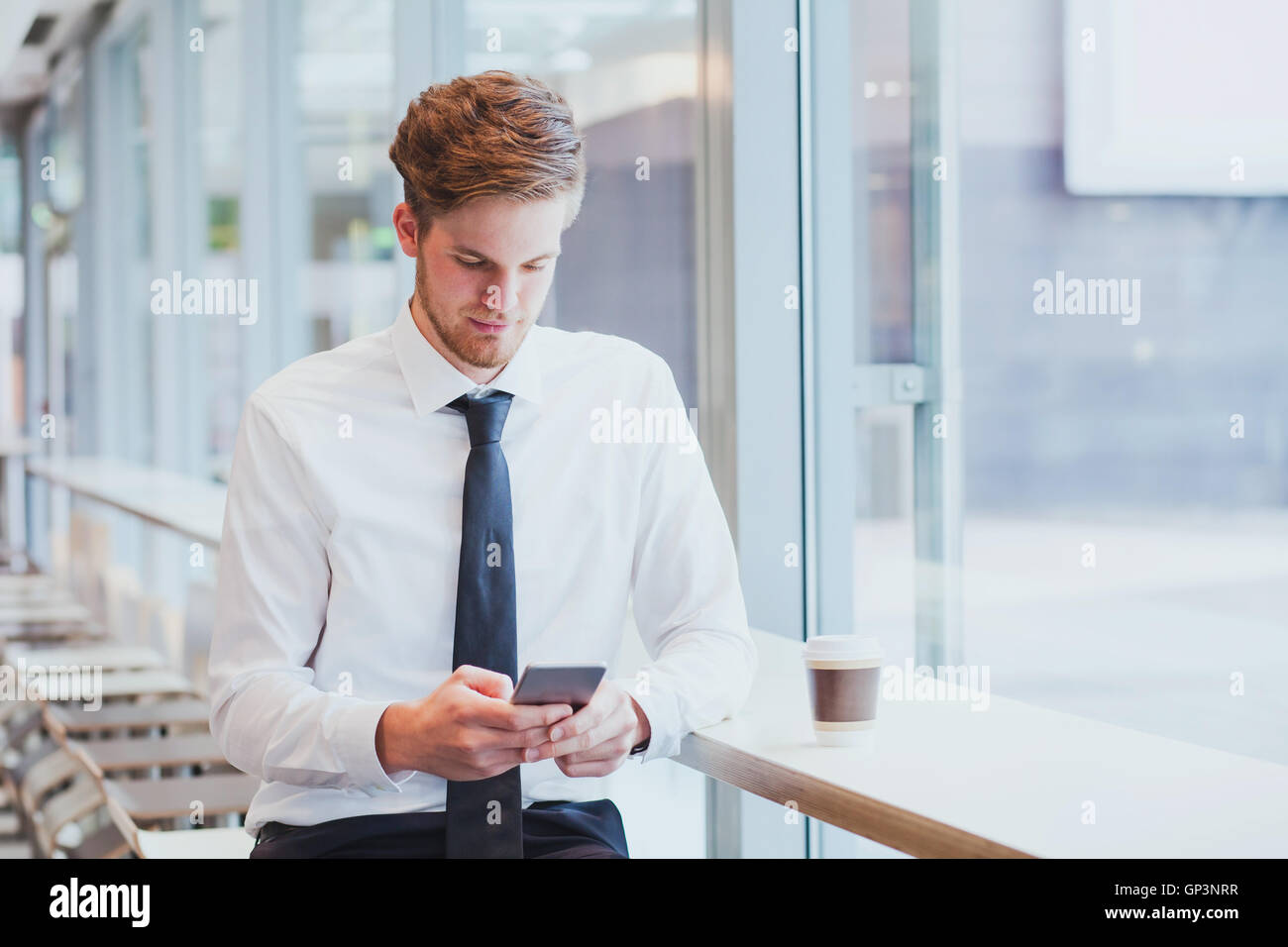 businessman reading news and emails on his smartphone Stock Photo