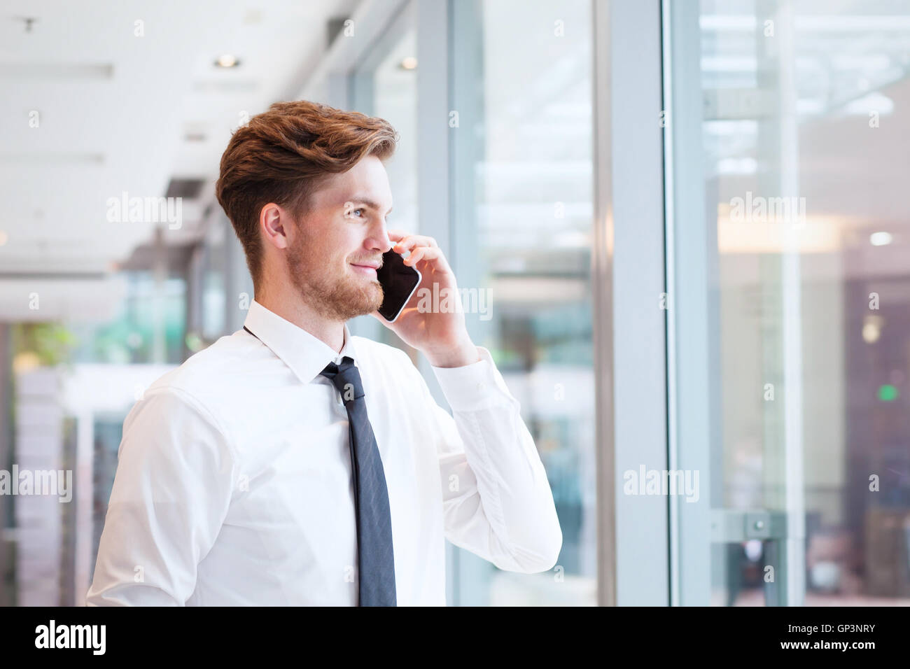 businessman talking on phone and smiling Stock Photo