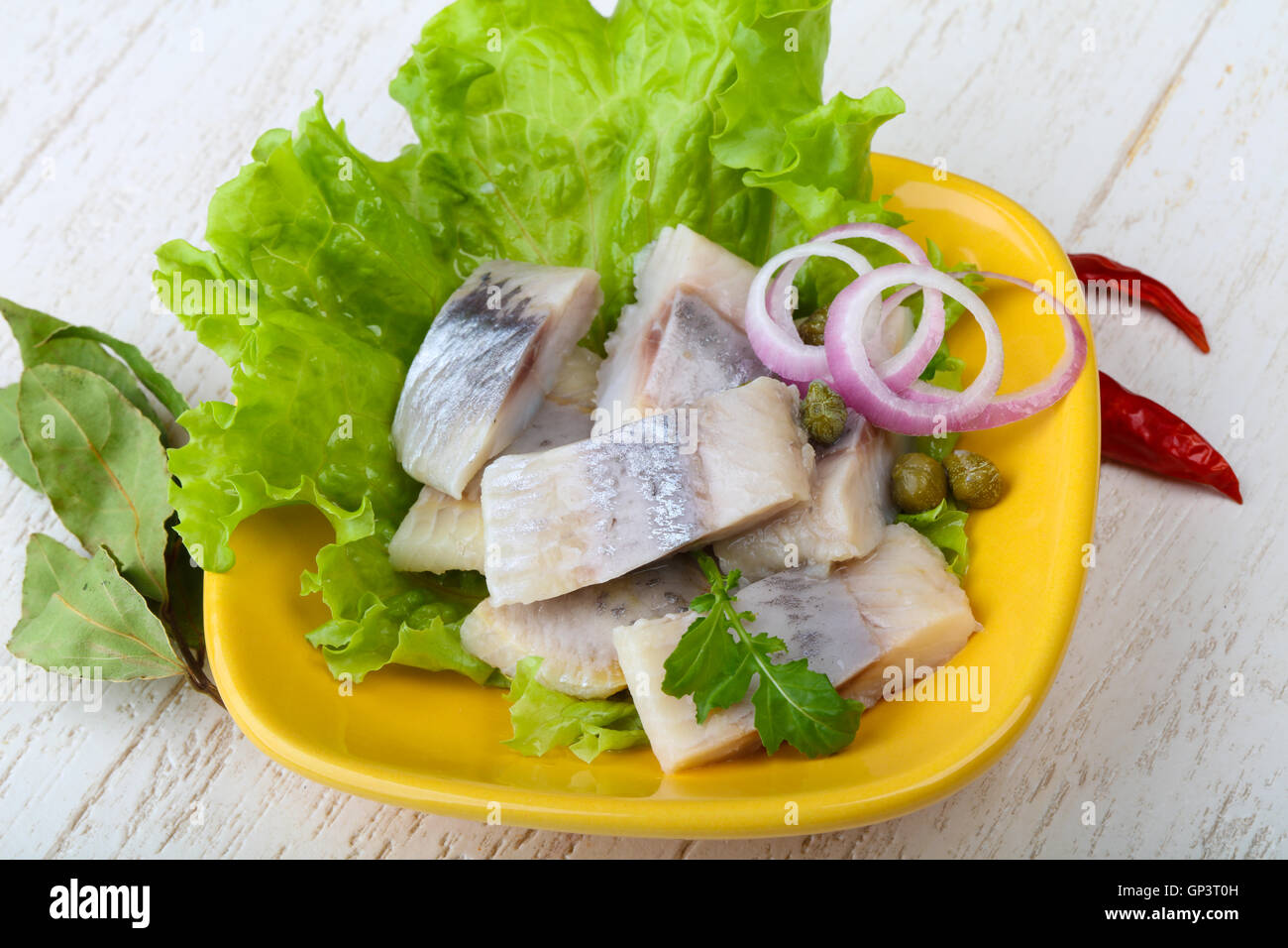 Herring fillet served onion and salad leaves Stock Photo Alamy