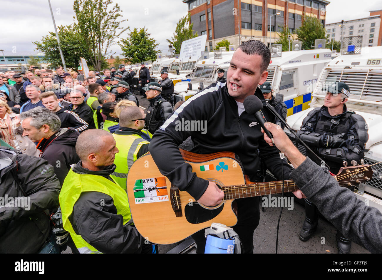 A man sings 'The Men Behind the Wire' at an Irish Republican protest after they were prevented from proceeding along a road. Stock Photo