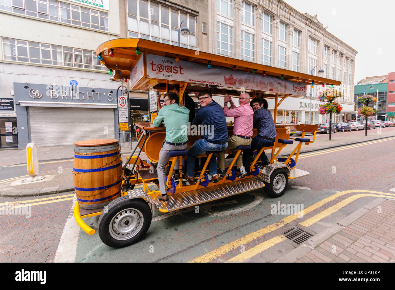 A number of people ride on the "Belfast Beer Bike", where they pedal  through the city while drinking beer Stock Photo - Alamy