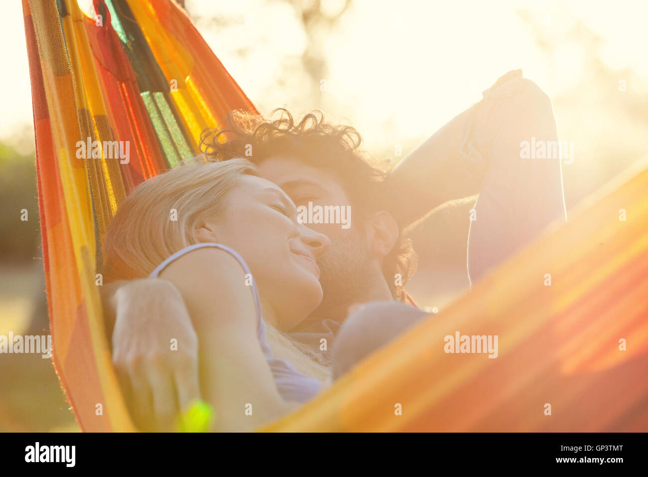 Couple napping together in hammock Stock Photo