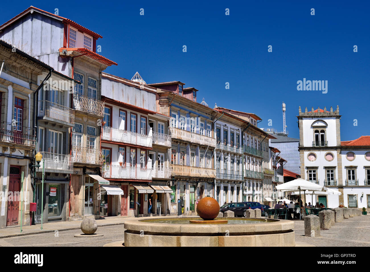 Portugal: Central town square  with fountain and medieval houses in the historic center of Guimaraes Stock Photo
