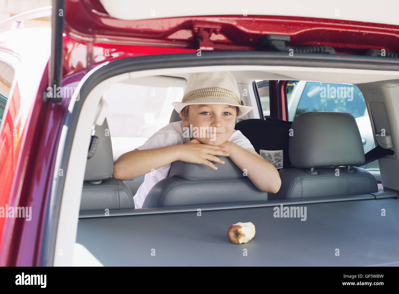 Boy looking out of back seat of car Stock Photo