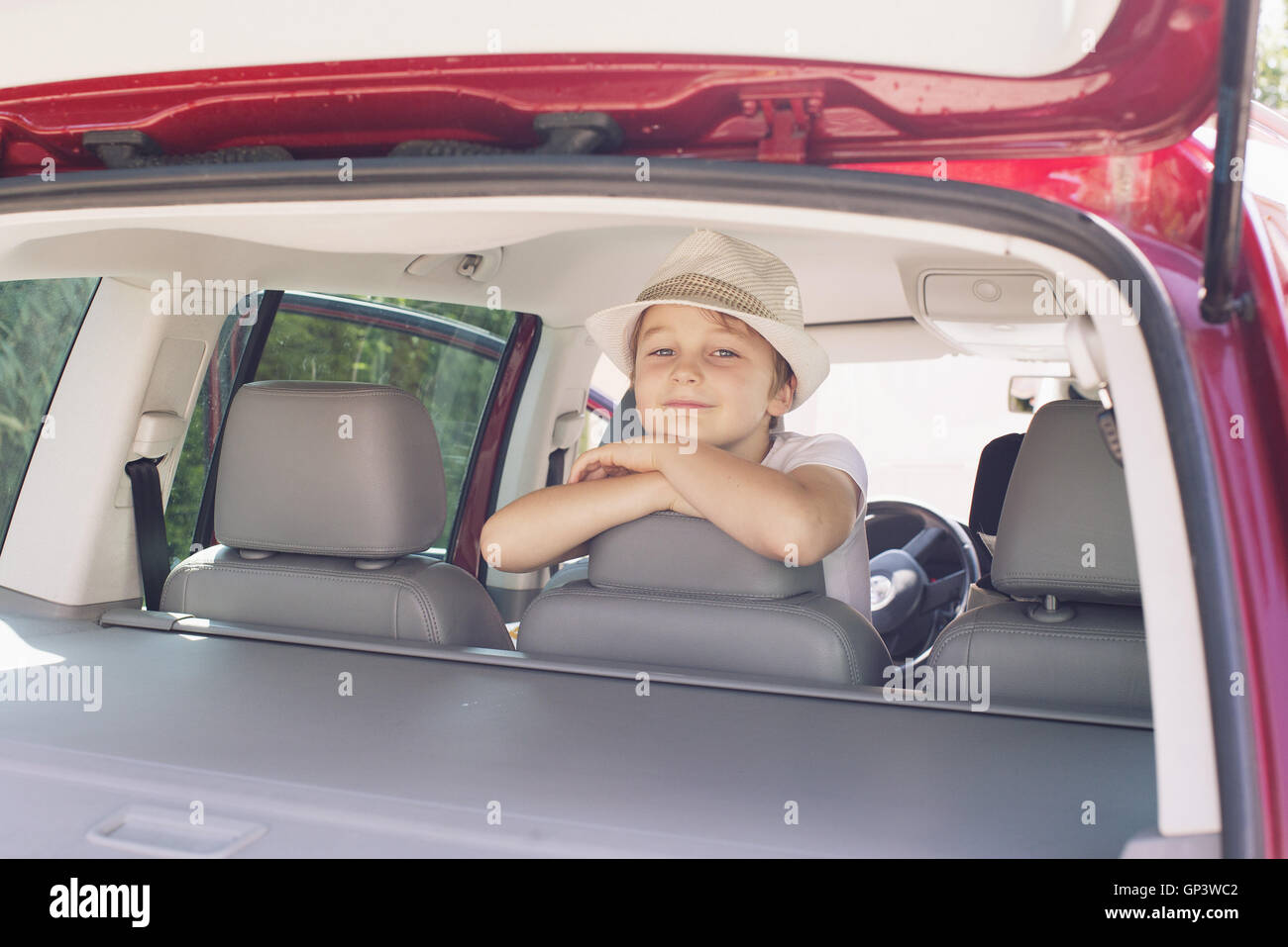 Boy looking out of back seat of car Stock Photo