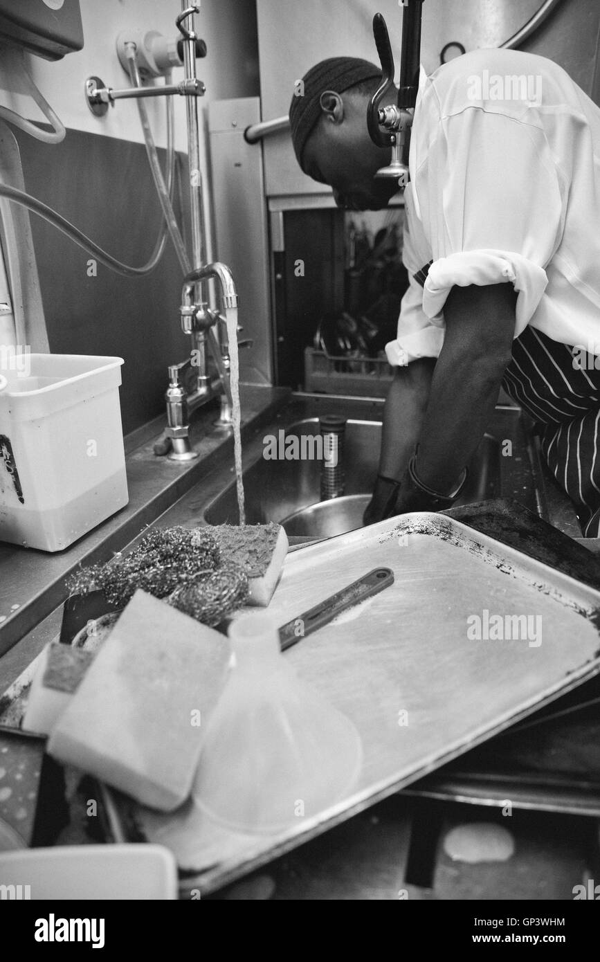 Worker washing dishes in commercial kitchen Stock Photo Alamy