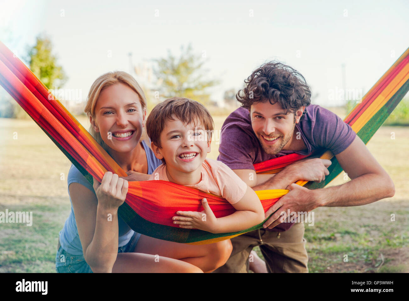 Family relaxing together outdoors, portrait Stock Photo