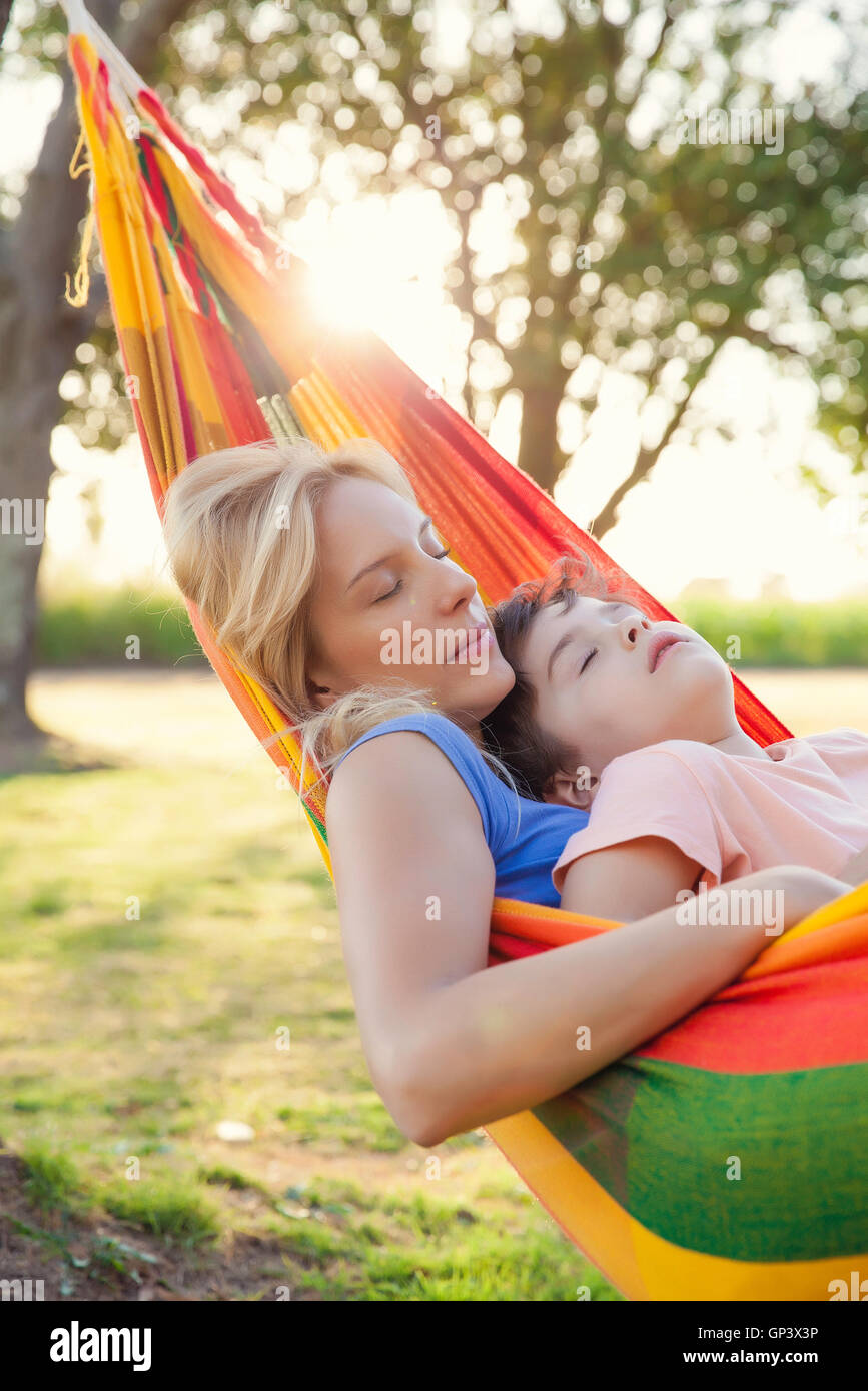 Mother and son napping together in hammock Stock Photo