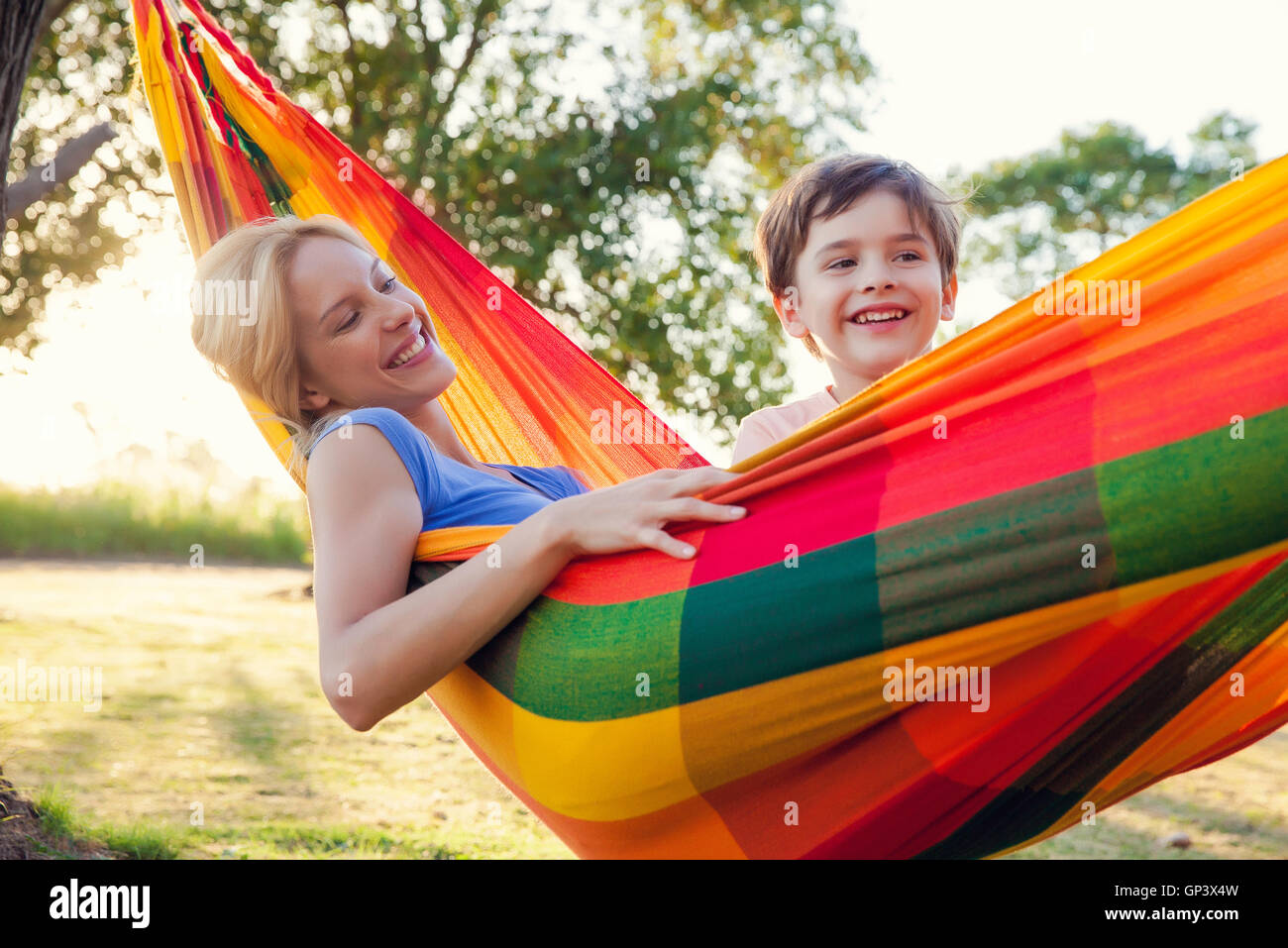 Mother and son relaxing together in hammock Stock Photo